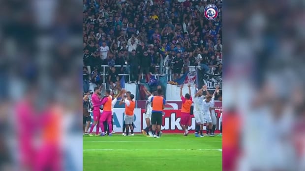Arema FC players and fans celebrate after win away at PSIS